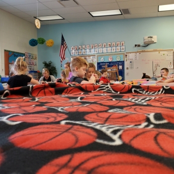 Students making blankets for My Very Own Blanket Organization.